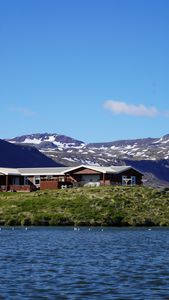 A serene remote cabin by a crystal-clear lake with stunning mountain views.