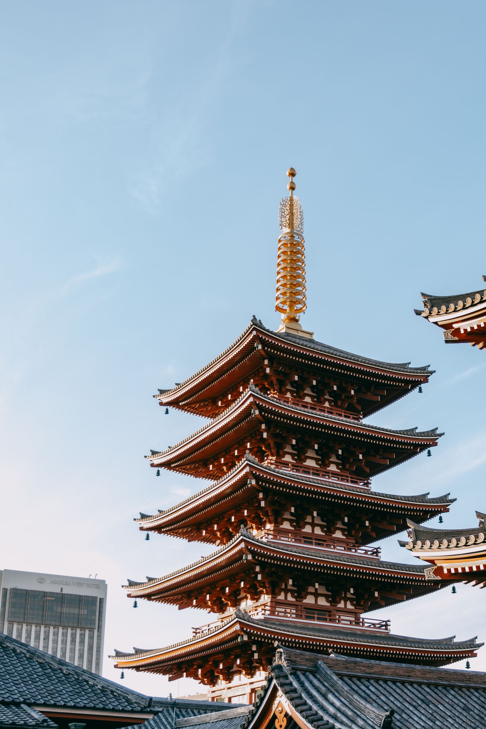 Elegant view of a historic pagoda in Asakusa, Tokyo under a clear sky.