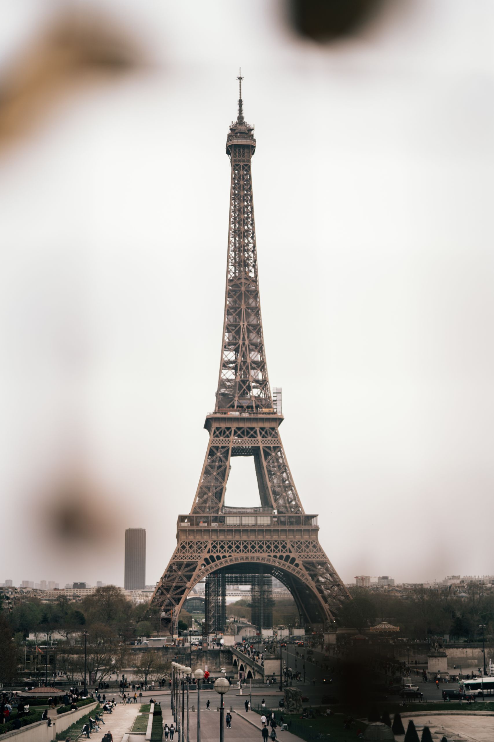 View of the iconic Eiffel Tower in Paris captured on a cloudy day, showcasing historic architecture.